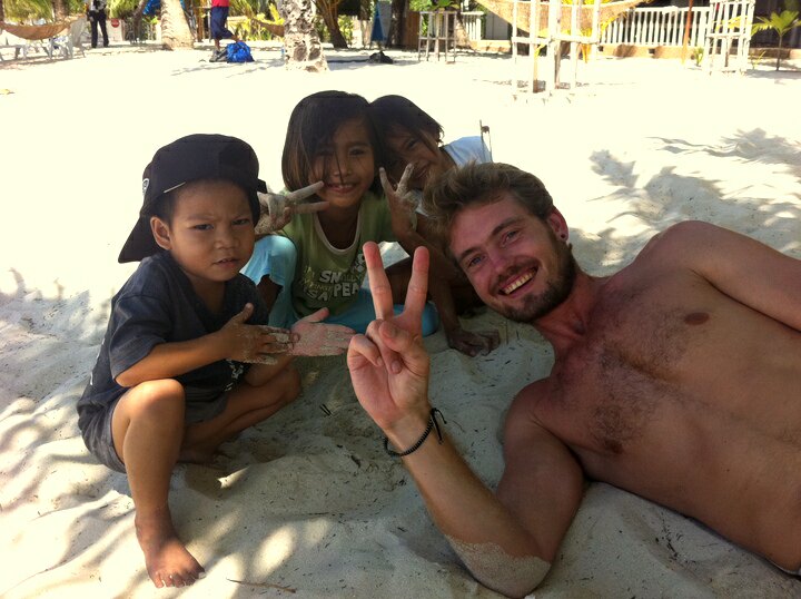 Bastiaan and local kids at a beach in Malapascua Island, Cebu